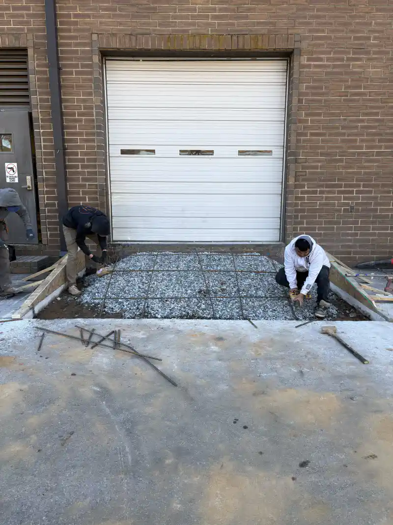 A poured concrete kerb and gutter run at a commercial site.