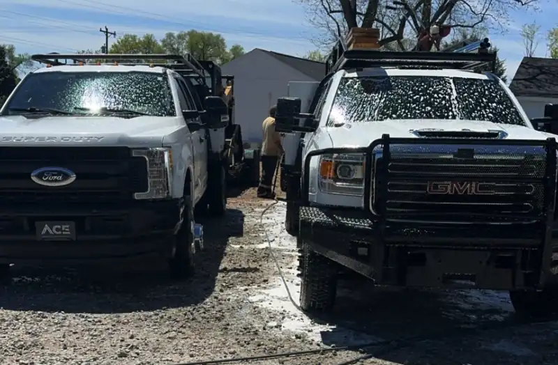 Ace Concrete Construction work trucks on a job site