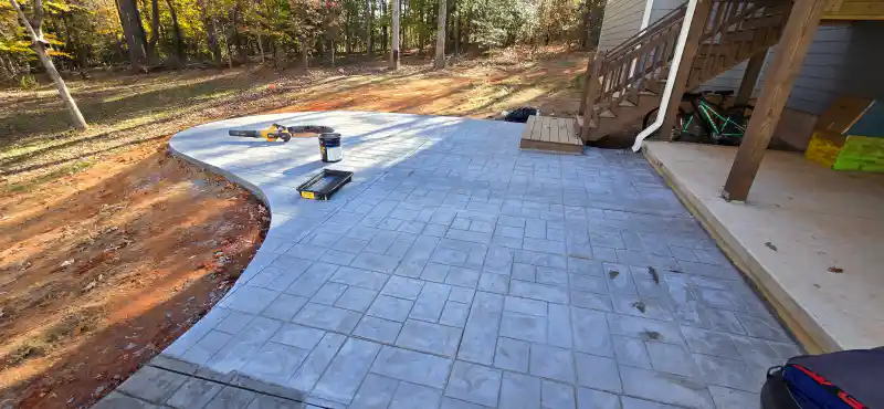 A stamped concrete patio in a stone pattern finished in warm brown tones.