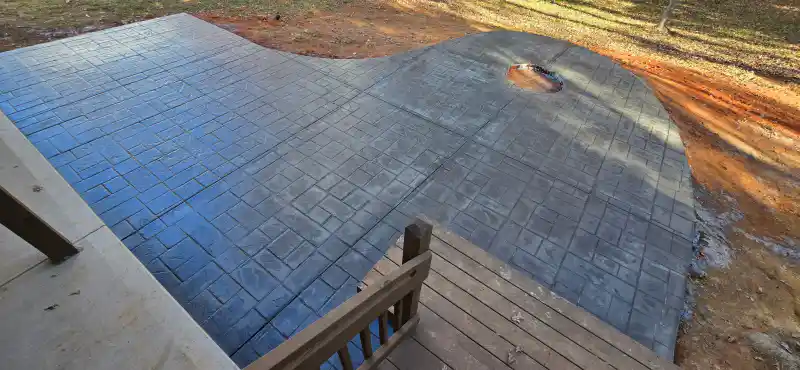 A stamped concrete surface with a jointed border band.