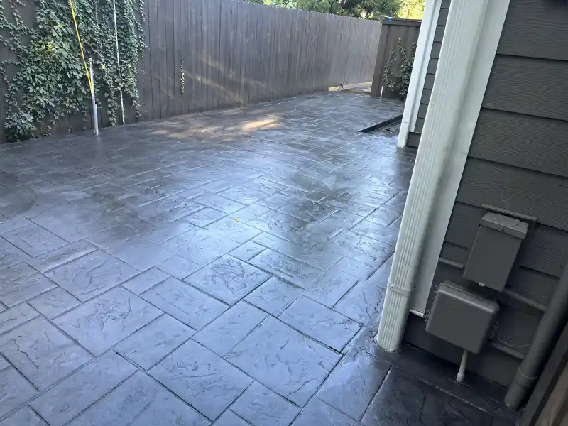 A stamped concrete patio area at a residential property.
