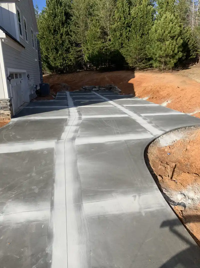 A concrete driveway and connecting walkway at a single-storey home.