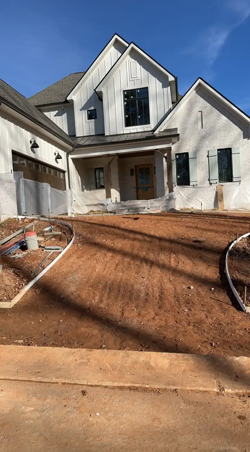 A broom-finished concrete driveway divided into jointed panels.