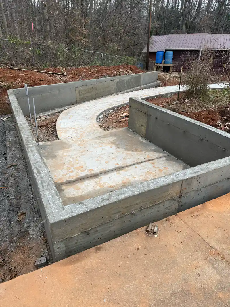 Formed concrete foundation walls with an adjoining poured slab.