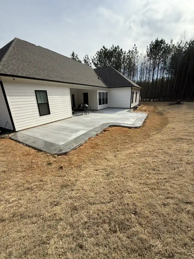 A concrete rear patio with a stepped change in level.