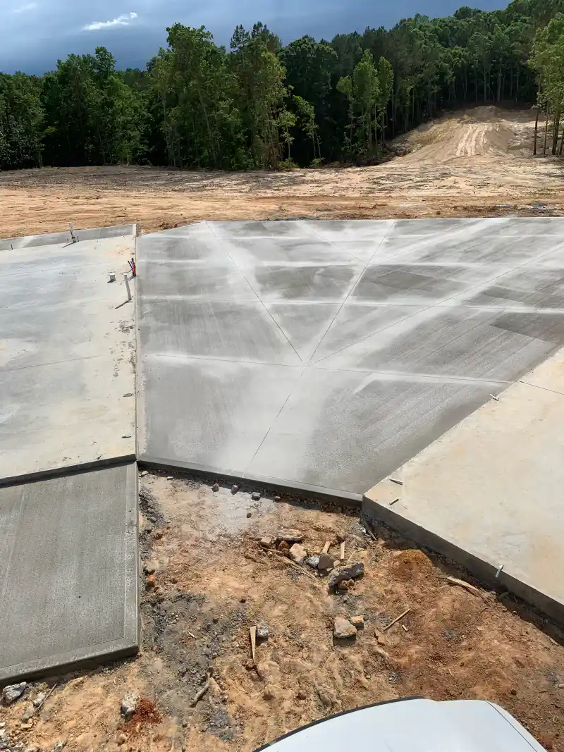 A concrete outdoor living area slab at a residential property.