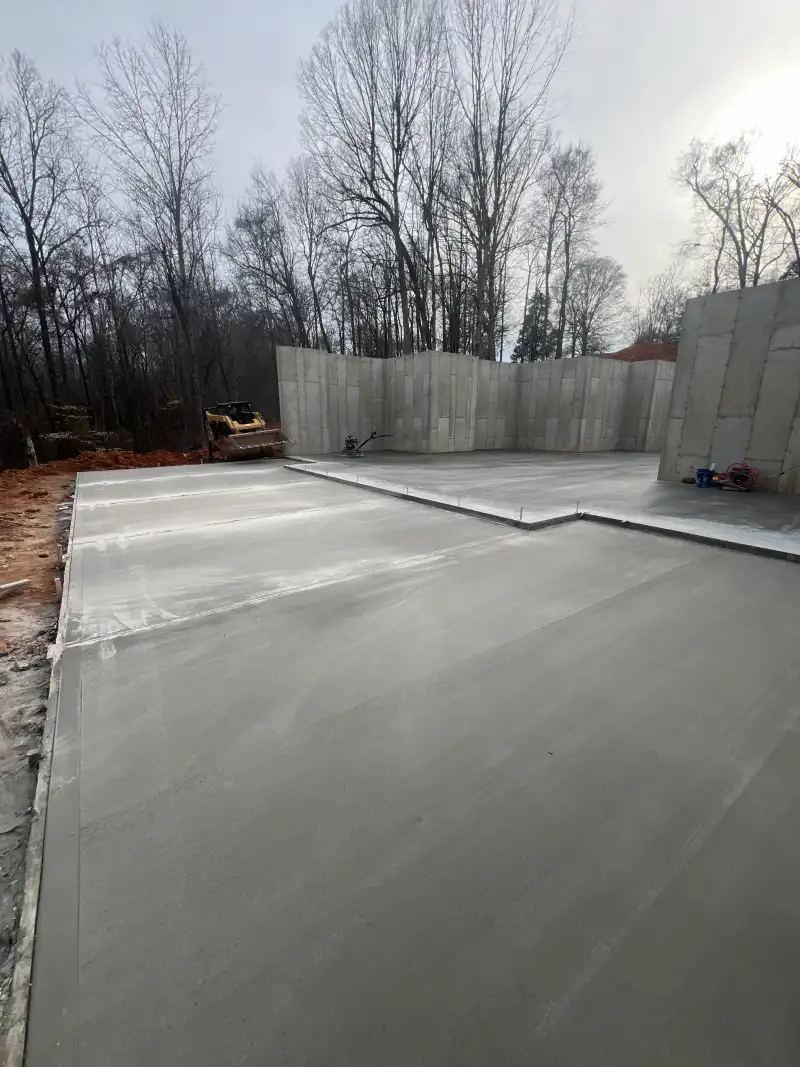 A concrete basement slab poured within surrounding foundation walls.