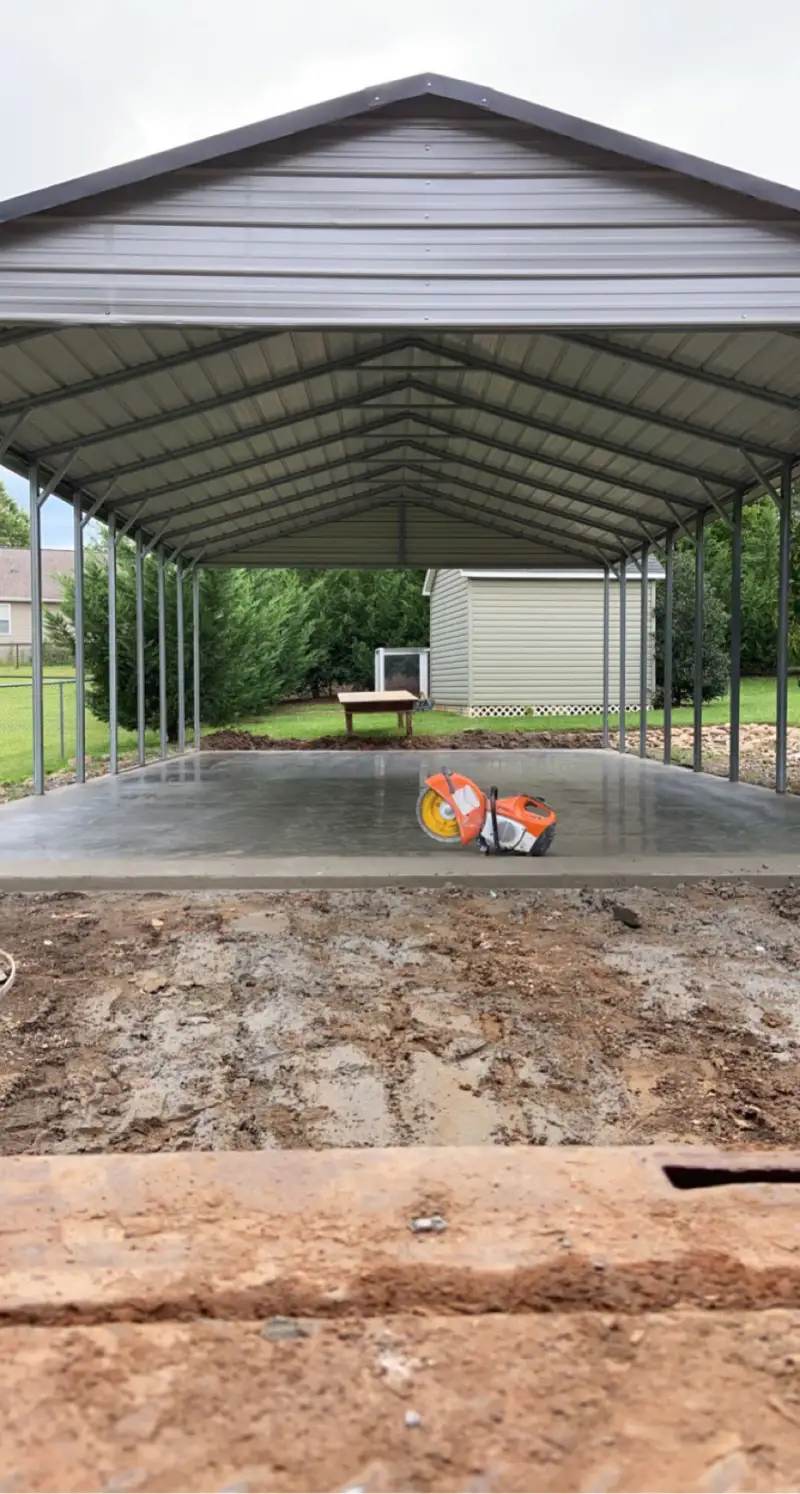 A concrete carport slab with structural support posts.