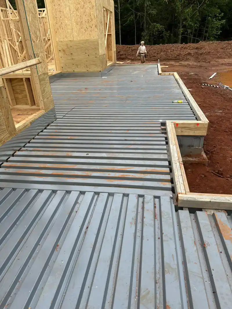 Corrugated steel decking installed as permanent formwork ready for an elevated concrete slab pour.