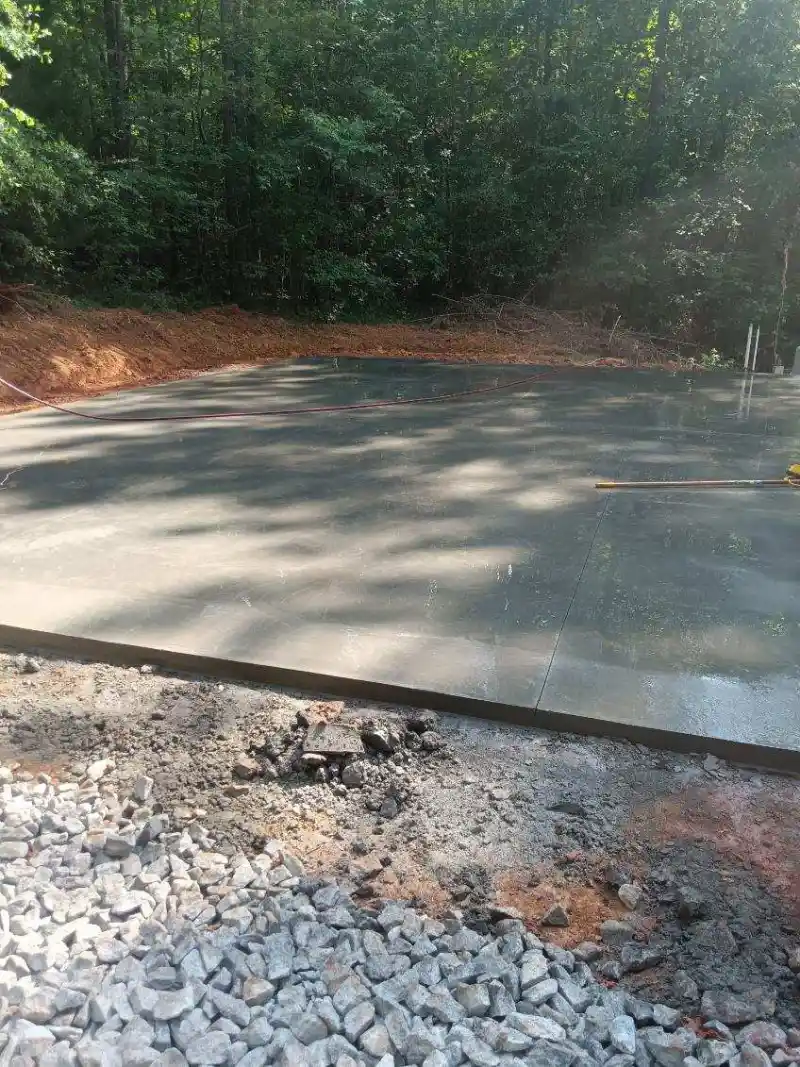 A concrete slab poured inside a metal building shell.